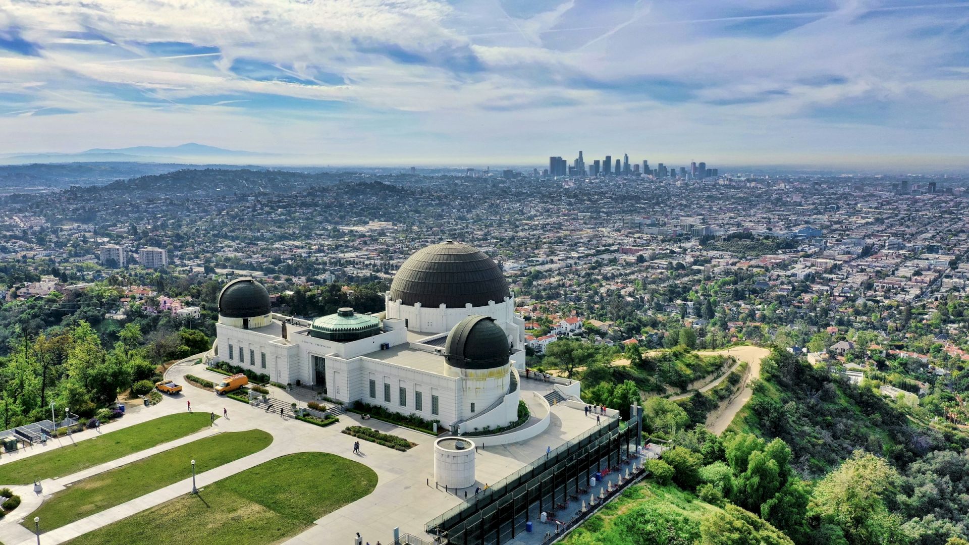 Aerial view of Griffith Observatory in Griffith Park with the Los Angeles skyline beyond